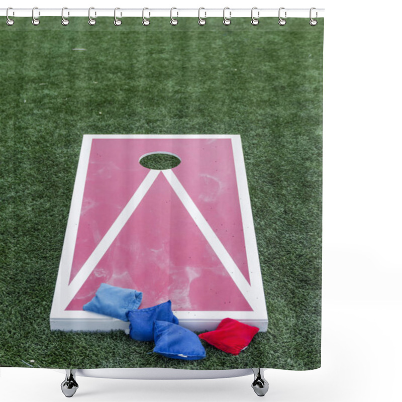 Personality  A Wood Red And White Corn Hole Board Is Set Up On A Green Turf Field With Blue And Red Bean Bags. Shower Curtains