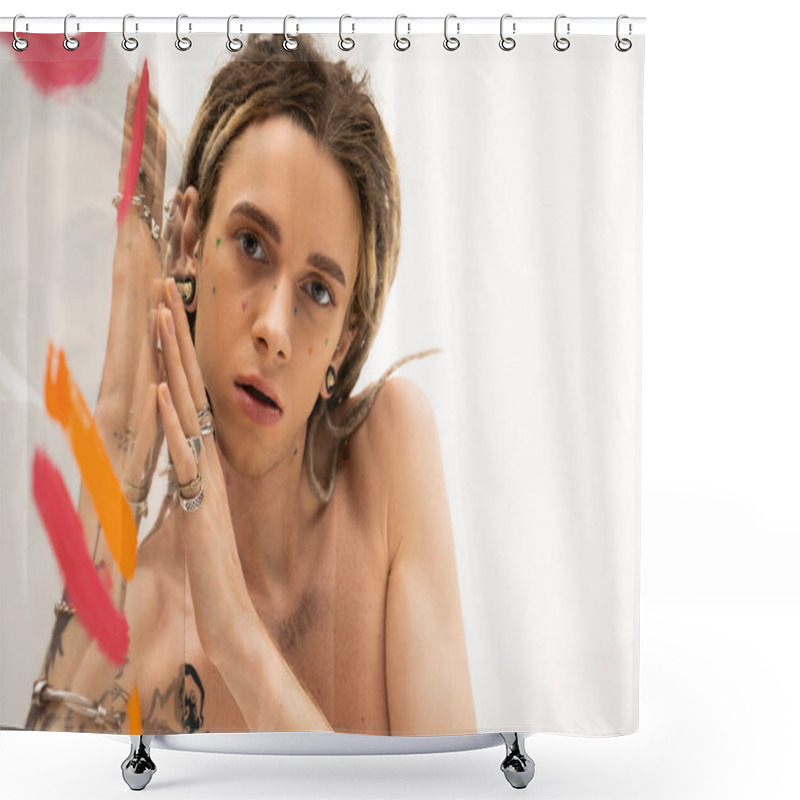 Personality  Portrait Of Shirtless Queer Model With Dreadlocks And Silver Rings Looking At Camera Near Glass With Colorful Paint On White Background Shower Curtains