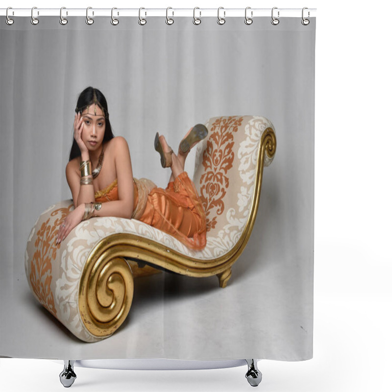 Personality  Full Length Portrait Of Pretty Young Asian Woman Wearing Golden Arabian Robes Like A Genie, Seated Pose On Lounge, Isolated On Studio Background. Shower Curtains