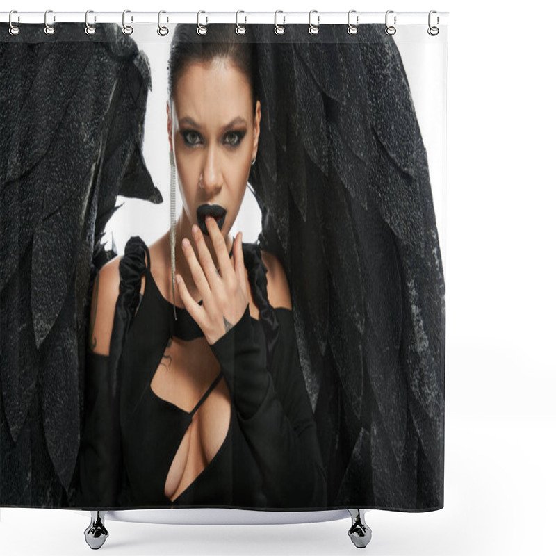 Personality  Portrait Of Passionate Woman In Dark Makeup And Costume Of Black Demon Touching Lips On White Shower Curtains