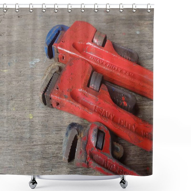 Personality  Two Weathered Red Pipe Wrenches Rest On A Rustic Wooden Surface, Showcasing Their Heavy-duty Construction.  Industrial Tools Concept. Shower Curtains