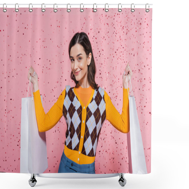 Personality  Pleased Woman In Stylish Cardigan Holding Shopping Bags And Smiling At Camera On Pink Background Shower Curtains