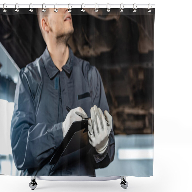 Personality  Cropped View Of Mechanic Writing On Clipboard While Standing Under Raised Car Shower Curtains