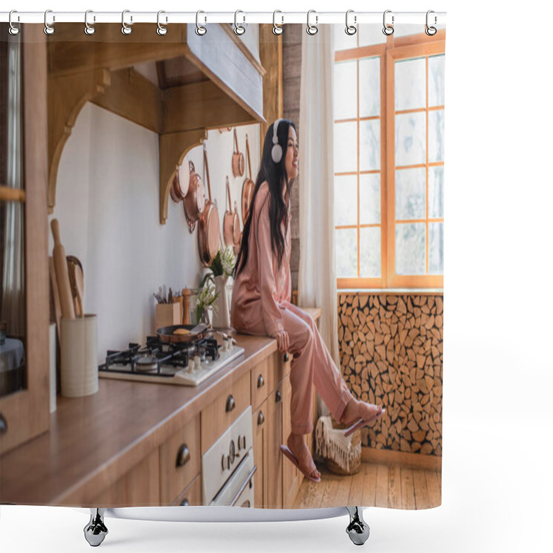 Personality  Smiling Young Asian Woman In Pink Silk Pajamas And Headphones Sitting Near Stove And Enjoying Music In Kitchen Shower Curtains