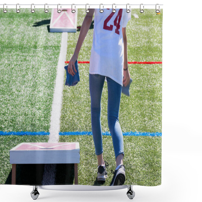 Personality  Rear View Of A High School Girl Throwing Bean Bags While Playing Corn Hole On A Green Turf Field On A Sunny Day. Shower Curtains