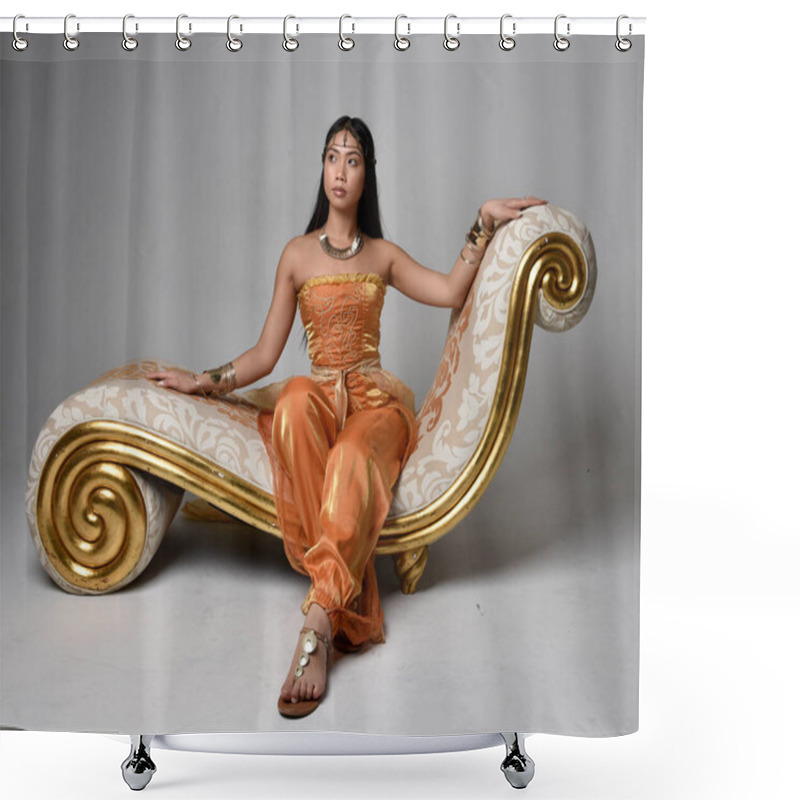 Personality  Full Length Portrait Of Pretty Young Asian Woman Wearing Golden Arabian Robes Like A Genie, Seated Pose On Lounge, Isolated On Studio Background. Shower Curtains