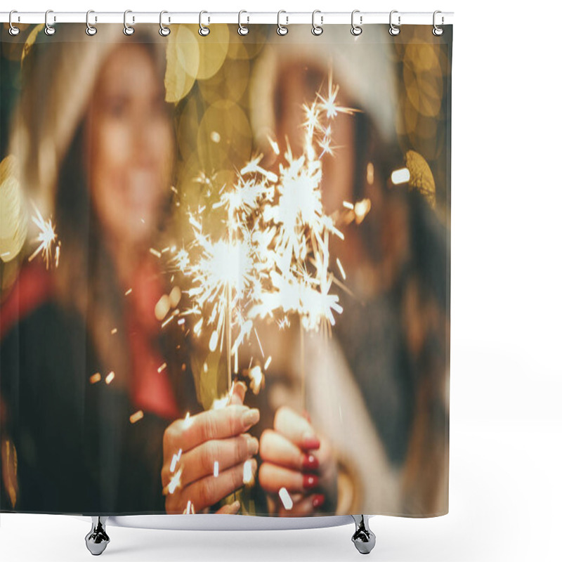 Personality  Cheerful Young Female Friends Are Holding Sparklers And Having Fun At Holiday Winter Night In The City Street. Selective Focus. Focus On A Sparklers. Shower Curtains