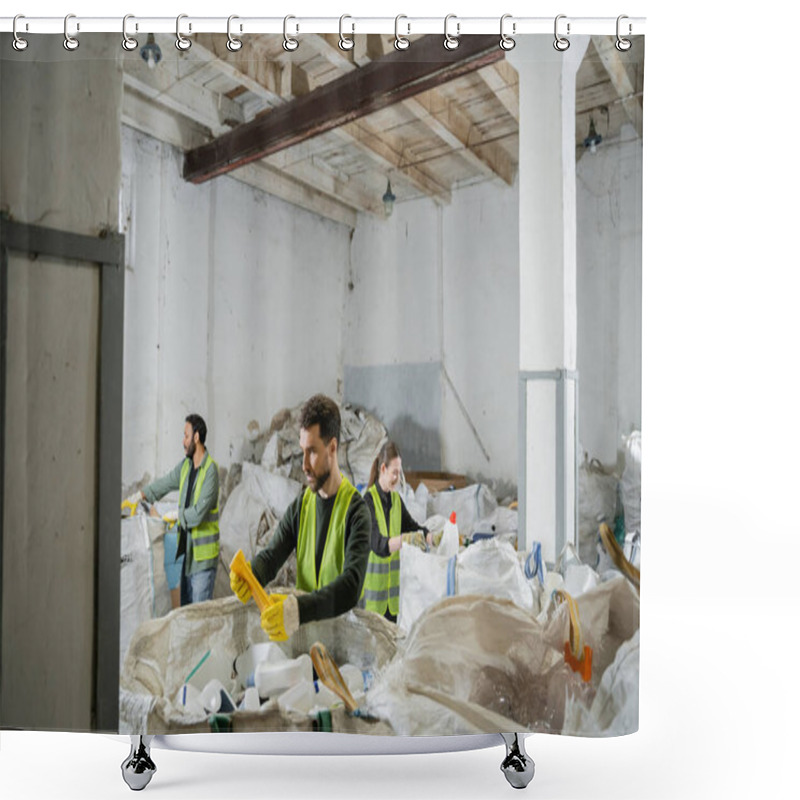 Personality  Male Worker In Protective Vest And Gloves Holding Plastic Trash While Standing Near Sacks And Blurred Interracial Colleagues In Waste Disposal Station, Garbage Sorting And Recycling Concept Shower Curtains