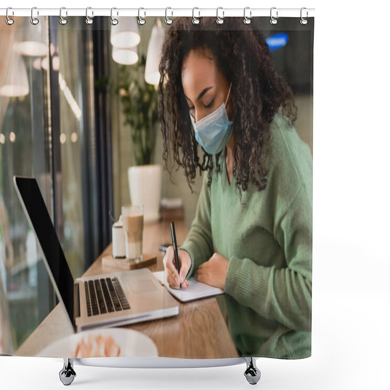 Personality  African American Woman In Medical Mask Writing In Notebook Near Laptop With Blank Screen On Table  Shower Curtains