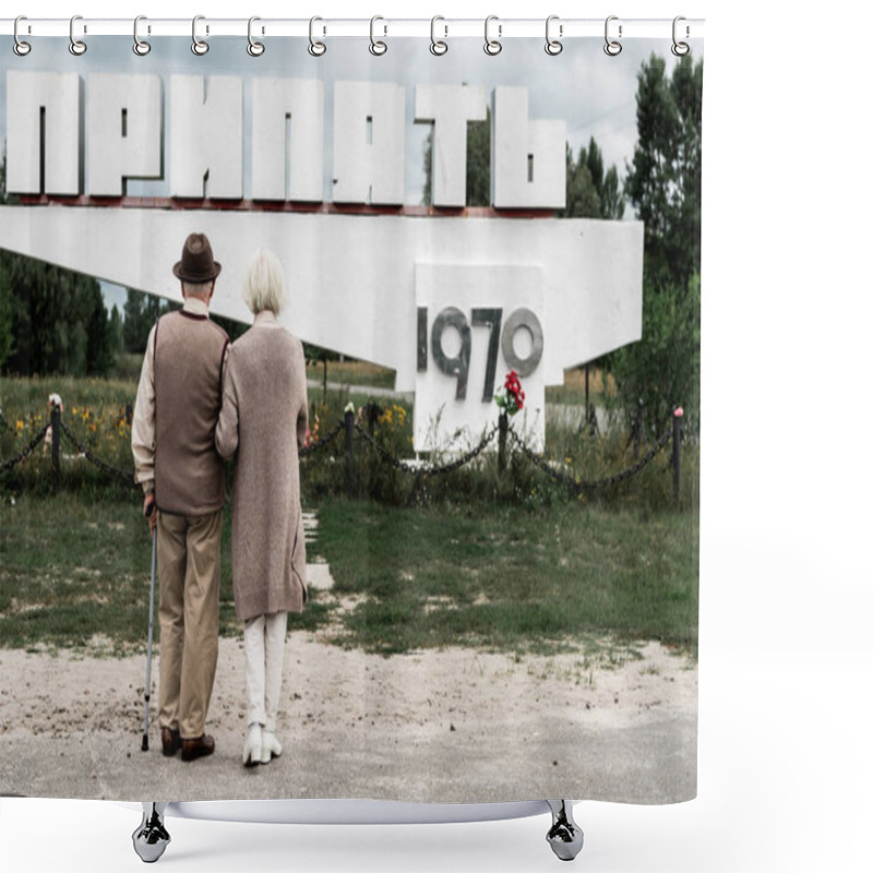 Personality  PRIPYAT, UKRAINE - AUGUST 15, 2019: Back View Of Retired Couple Standing Near Monument With Pripyat Letters Shower Curtains