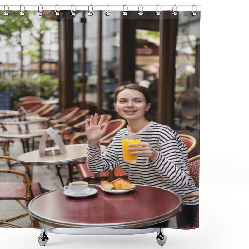 Personality  Happy Woman In Striped Long Sleeve Shirt Holding Glass Of Orange Juice And Waving Hand In Outdoor Cafe In Paris Shower Curtains