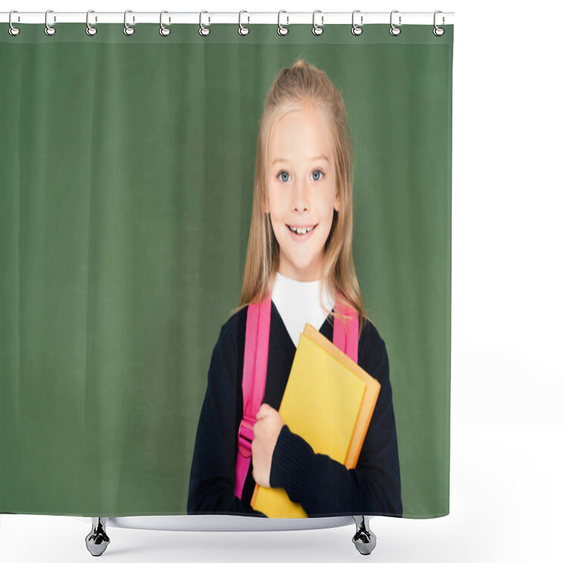 Personality  Cheerful Schoolgirl Holding Book And Smiling At Camera While Standing Near Green Chalkboard Shower Curtains