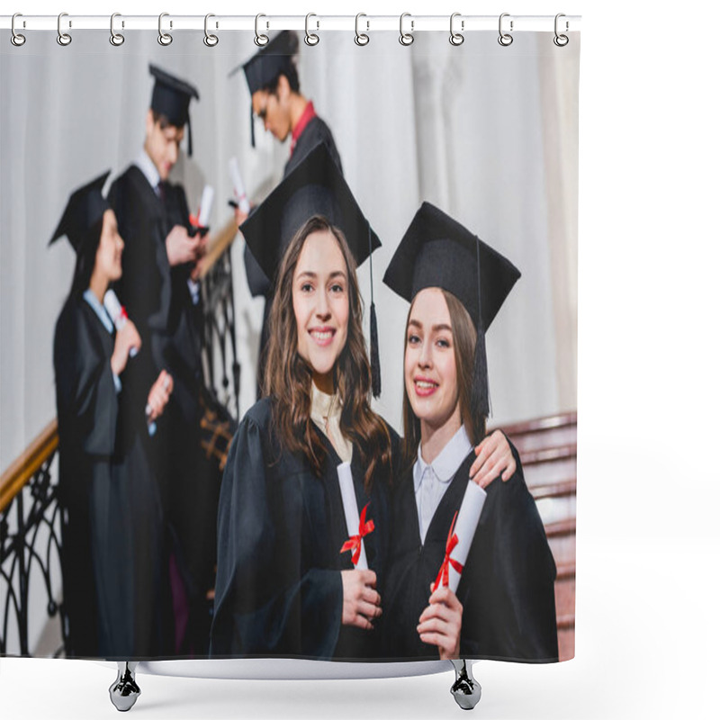 Personality  Selective Focus Of Beautiful Girls In Graduation Caps Smiling While Holding Diplomas Near Students Shower Curtains