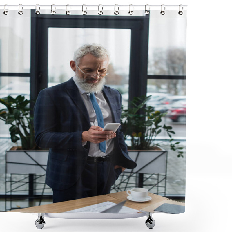 Personality  Smiling Mature Businessman In Suit Using Smartphone Near Notebooks And Coffee In Office  Shower Curtains