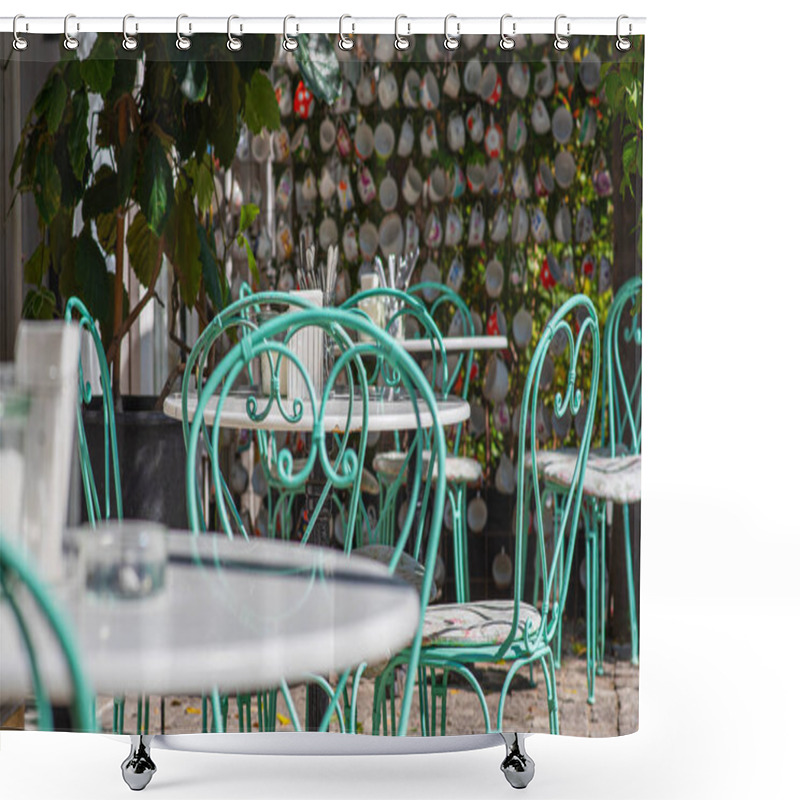 Personality  A Cozy Outdoor Cafe With Turquoise Wrought-iron Chairs And White Marble Tables. The Backdrop Of Colorful Hanging Teacups Creates A Charming, Whimsical Atmosphere Bathed In Soft Sunlight. Shower Curtains