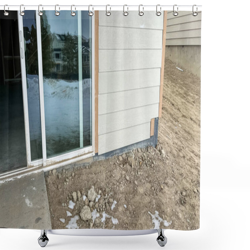 Personality  Under-construction Backyard Patio Area Featuring A Sliding Glass Door Leading To A Small Concrete Step Surrounded By Dirt And Snow. The Unfinished Landscaping And Exposed Ground Highlight The Early Shower Curtains