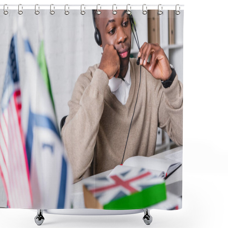 Personality  Thoughtful African American Translator In Headset Working Near International Flags And Dictionaries On Blurred Foreground Shower Curtains