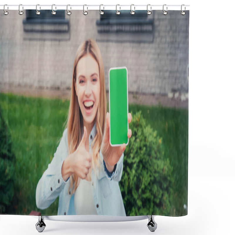 Personality  Blurred And Cheerful Student Holding Smartphone With Green Screen While Showing Thumb Up Near Building  Shower Curtains