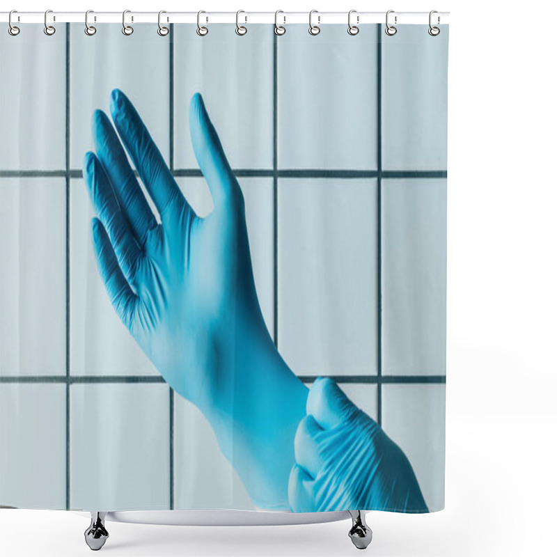 Personality  Cropped Shot Of Medical Worker Putting On Blue Rubber Gloves In Front Of Tiled White Wall Shower Curtains