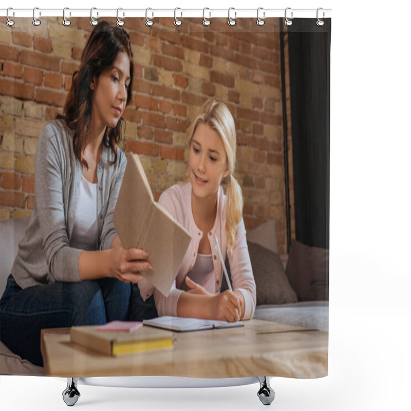 Personality  Selective Focus Of Mother Holding Book Near Smiling Daughter Writing On Notebook On Coffee Table  Shower Curtains