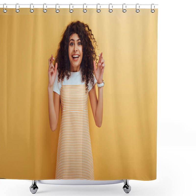 Personality  Excited Bi-racial Girl Holding Crossed Fingers While Smiling At Camera On Yellow Background Shower Curtains