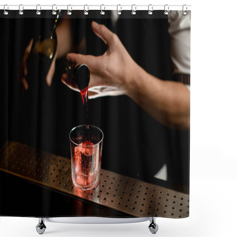 Personality  Close-up. Barmans Hand Holds Jigger And Pours Red Liquid Into Glass With Ice Shower Curtains