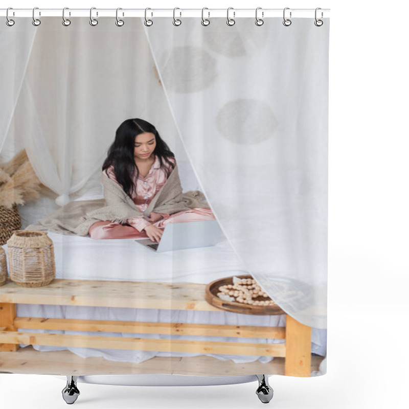 Personality  Serious Young Asian Woman In Silk Pajamas And Blanket Sitting On Bed With Crossed Legs And Typing On Laptop In Bedroom Shower Curtains