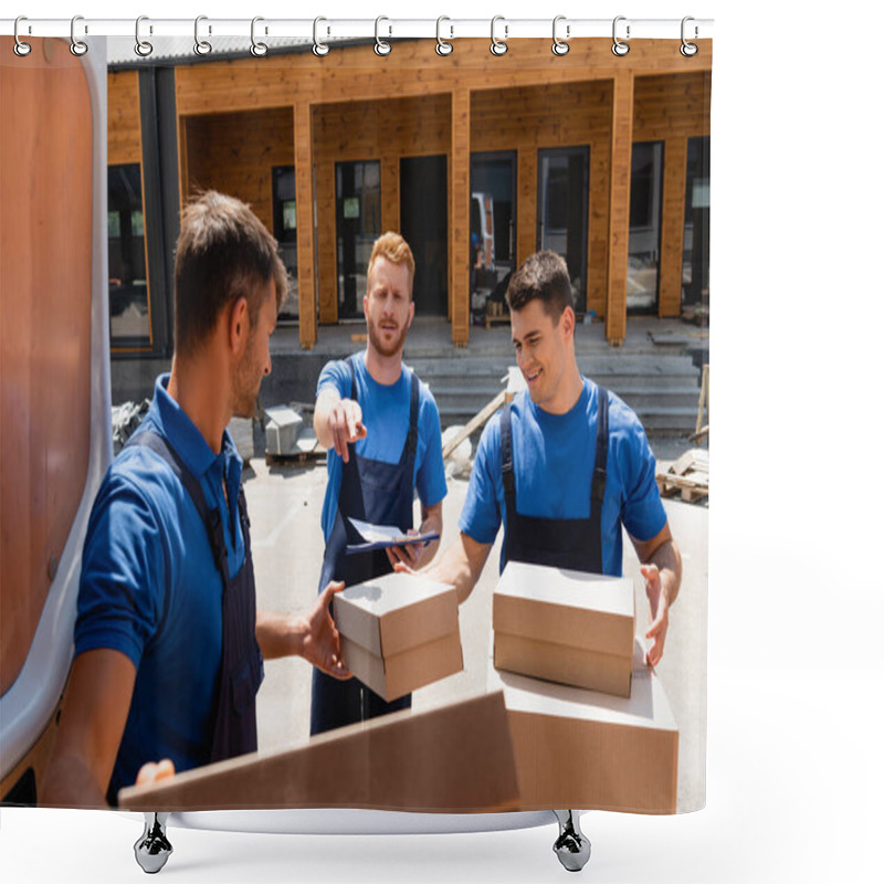 Personality  Selective Focus Of Loader With Clipboard Pointing With Finger Near Colleagues While Unloading Cardboard Boxes In Truck On Urban Street  Shower Curtains