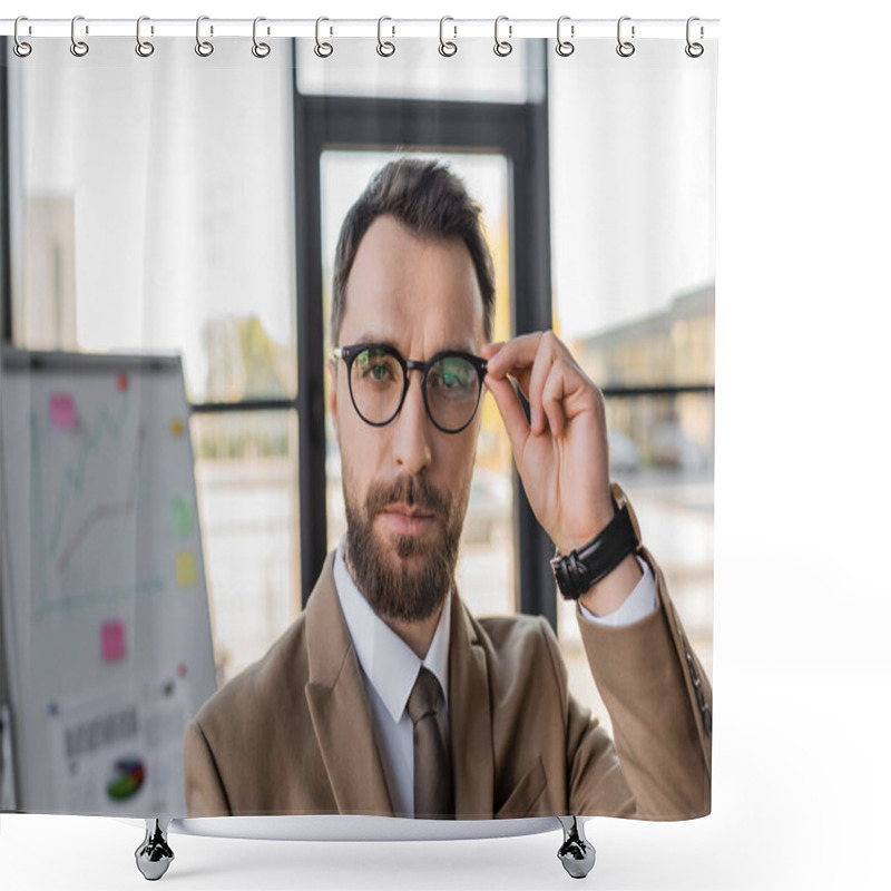 Personality  Bearded Successful Businessman In Beige Blazer And Tie Adjusting Stylish Eyeglasses And Looking At Camera Near Flip Chart With Graphs On Blurred Background  Shower Curtains