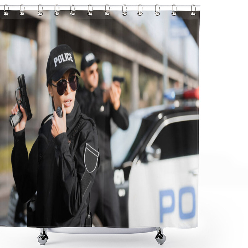 Personality  Policewoman In Sunglasses Holding Gun And Using Walkie Talkie Near Colleague And Car On Blurred Background  Shower Curtains