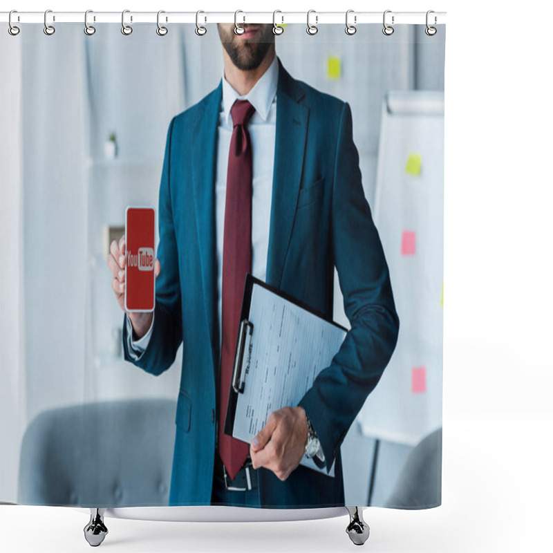 Personality  KYIV, UKRAINE - JUNE 10, 2019: Cropped View Of Bearded Man Holding Clipboard And Smartphone With Youtube App On Screen  Shower Curtains