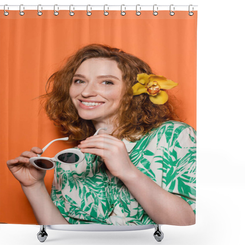 Personality  Positive Young Red Haired Woman With Orchid Flower In Hair Looking At Camera And Holding Sunglasses And Standing On Orange Background, Summer Casual And Fashion Concept, Youth Culture Shower Curtains