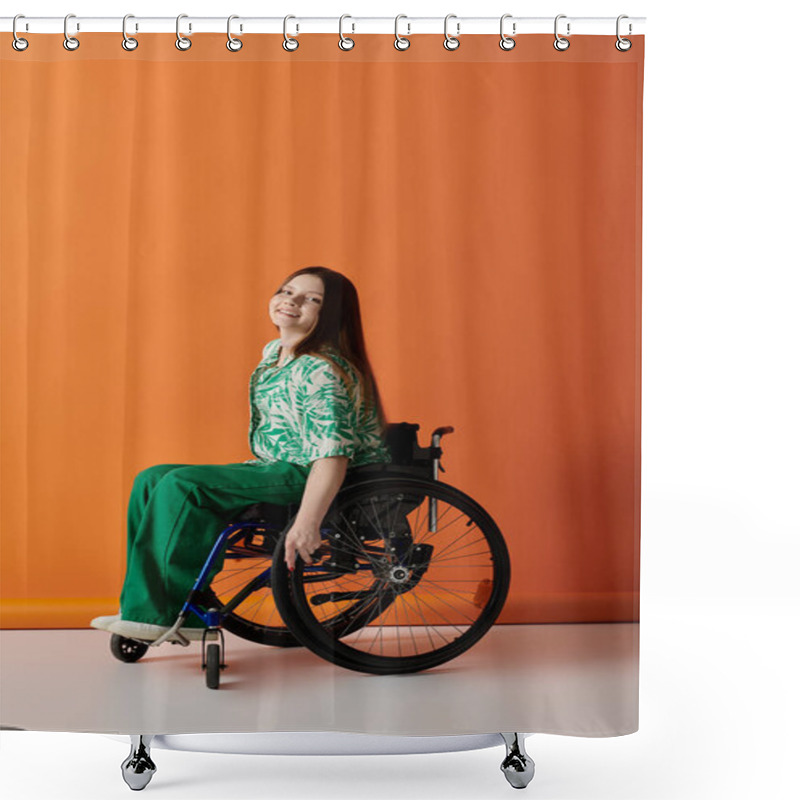 Personality  A Young Woman With Long Hair Sits In A Wheelchair Against An Orange Background, Dressed In Green And Smiling Confidently. Shower Curtains