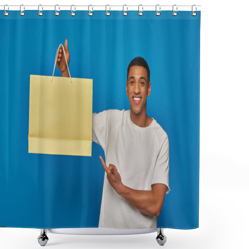 Personality  Joyful African American Man In Casual Attire Pointing At Shopping Bag On Blue Backdrop, Buying Spree Shower Curtains