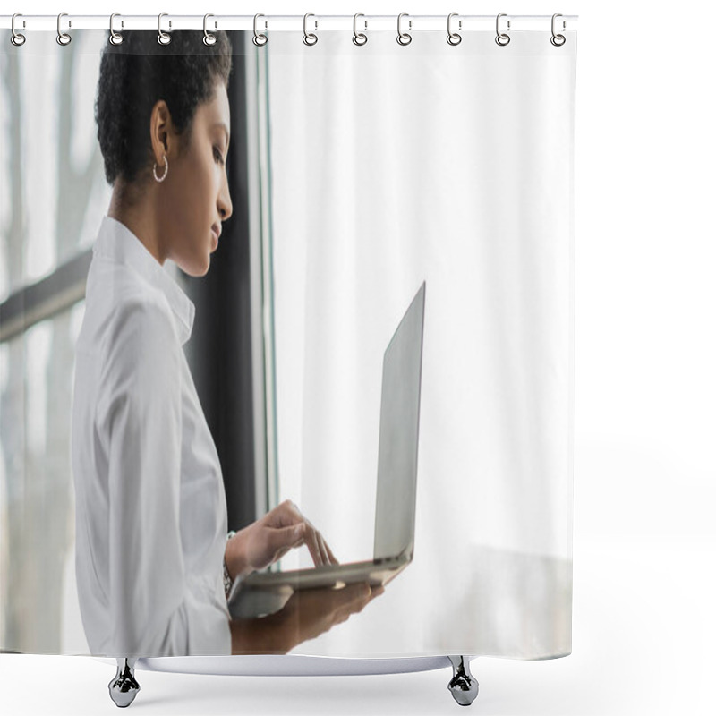 Personality  Side View Of African American Businesswoman In White Blouse Standing Near Window In Office And Using Laptop Shower Curtains