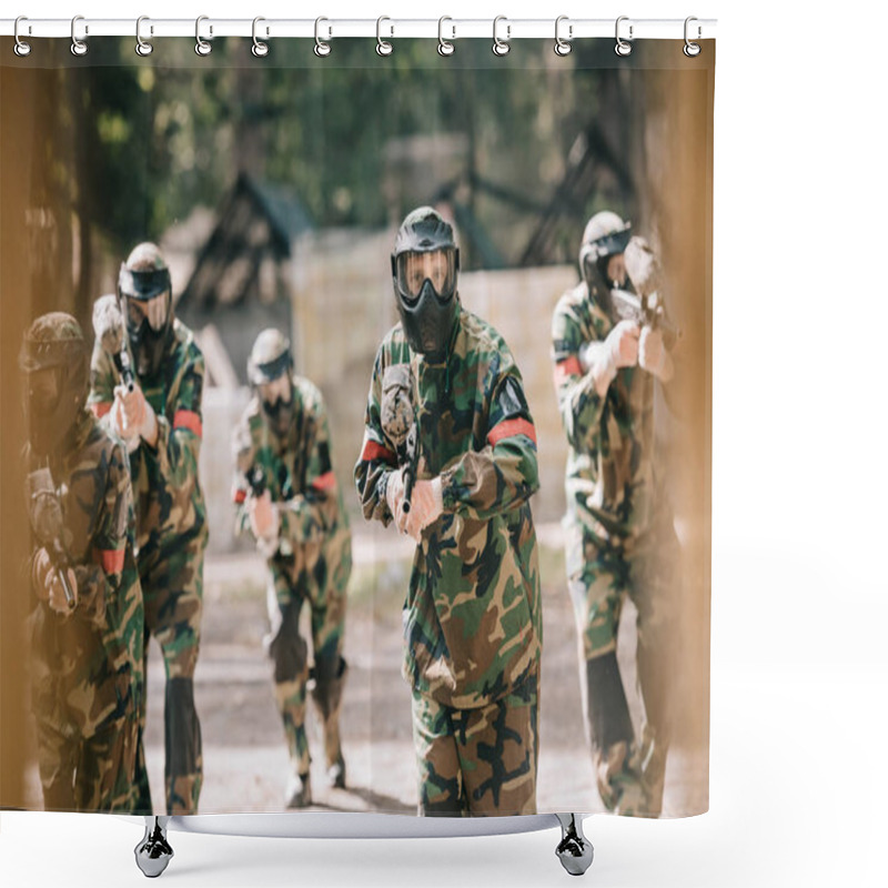 Personality  Selective Focus Of Paintball Team In Uniform And Protective Masks Playing Paintball With Marker Guns Outdoors Shower Curtains