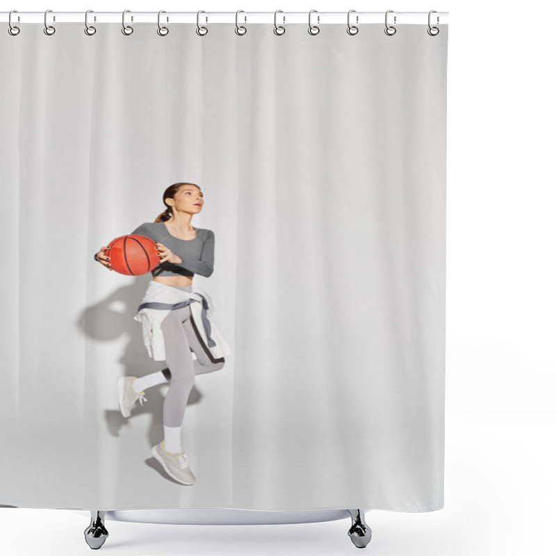 Personality  A Sporty Young Woman In Active Wear Gracefully Holds A Basketball Against A Grey Background. Shower Curtains