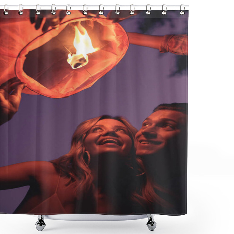 Personality  Low Angle View Of Happy Young Couple Launching Sky Lantern On River Beach In Evening Shower Curtains