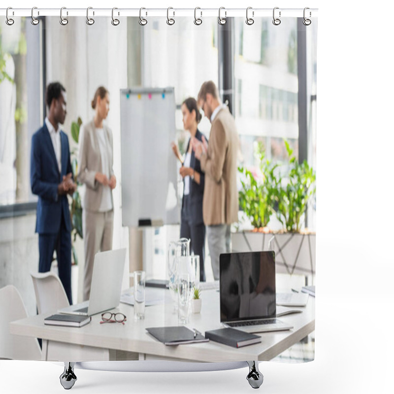 Personality  Selective Focus Of Four Multiethnic Businesspeople Near Flipchart And Table With Laptops And Glasses Of Water On Foreground Shower Curtains