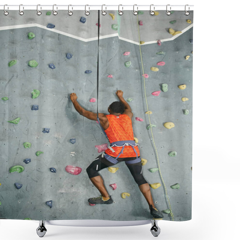 Personality  Back View Of African American Man In Orange Shirt Climbing Actively Up Rock Wall, Bouldering Concept Shower Curtains