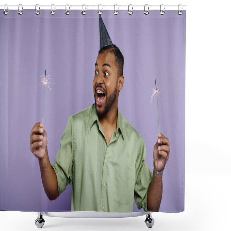 Personality  Young African American Man With Braces, Smiling, Holds Two Sparklers In Party Hat Against Vibrant Purple Background. Shower Curtains