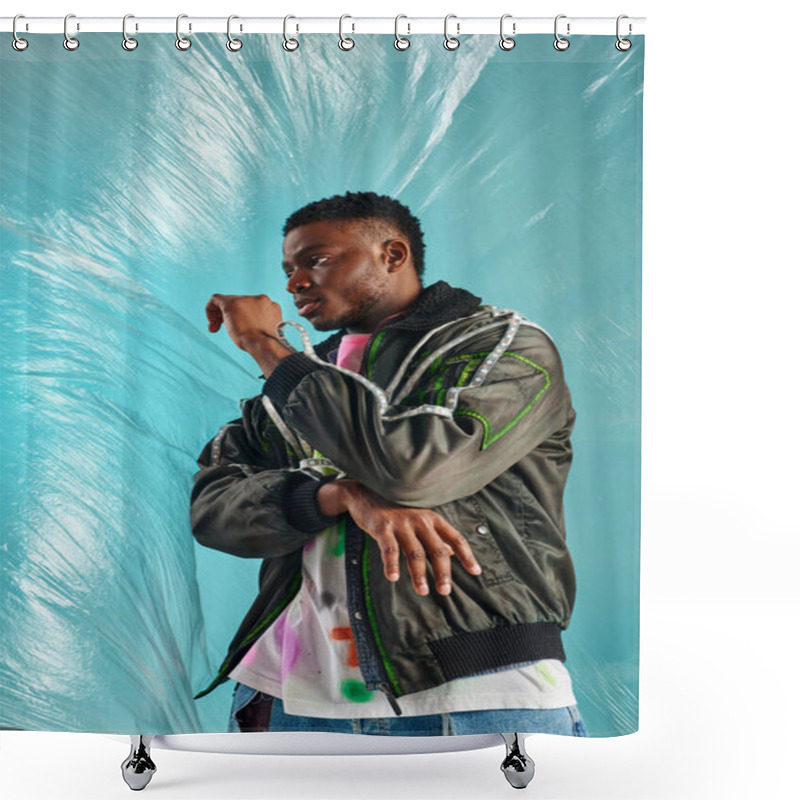 Personality  Fashionable Young Afroamerican Model In Outwear Jacket With Led Stripes Looking Away Near Glossy Cellophane On Turquoise Background, Urban Outfit And Modern Pose, Creative Expression, DIY Clothing  Shower Curtains