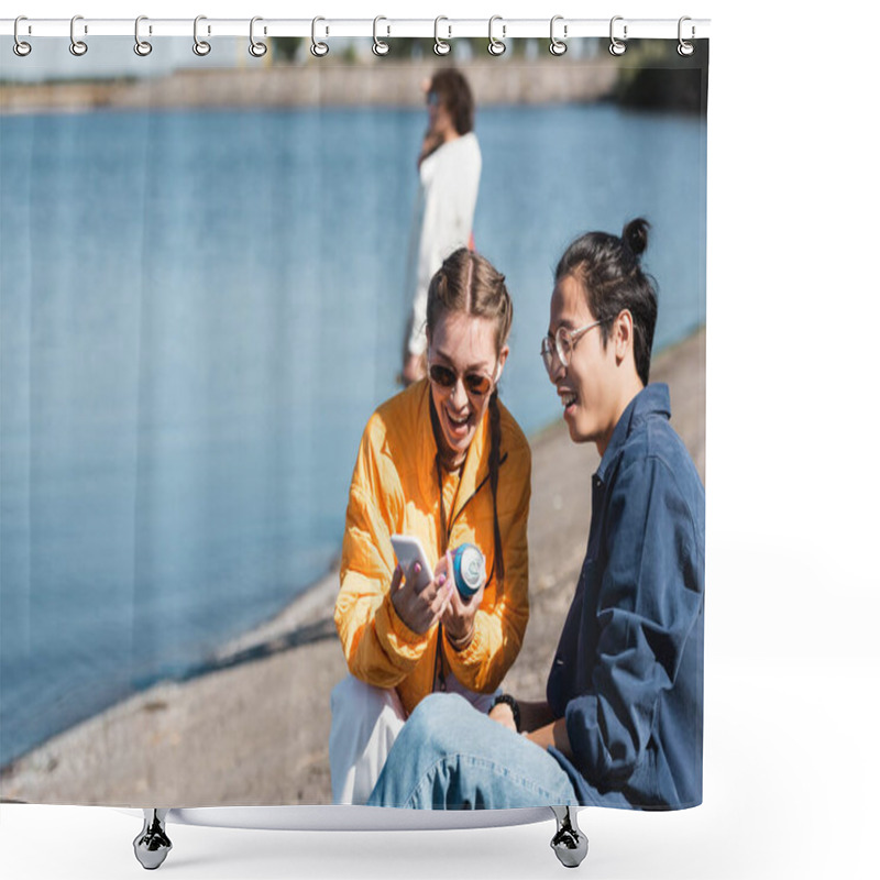 Personality  Cheerful Woman With Soda Can Showing Smartphone To Asian Friend Near River Shower Curtains