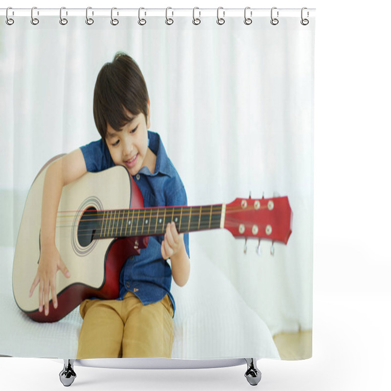 Personality  Happy Cheerful Asian Little Young Boy Practices Playing An Acoustic Guitar In Bedroom. Lovely Asian Little Boy Playing A Guitar. Shower Curtains