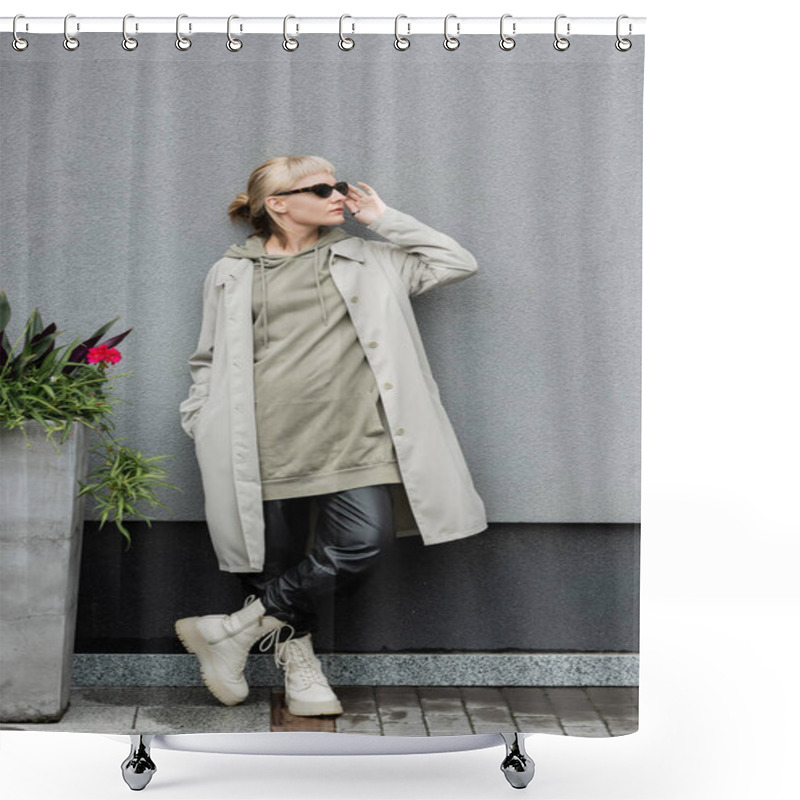 Personality  Full Length Of Young Woman In Stylish Sunglasses, Long Hoodie, Coat, Black Leather Pants And Beige Boots Standing Near Grey Wall Of Modern Building And Posing With Hand In Pocket Near Green Plant  Shower Curtains