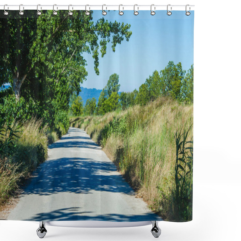 Personality  A Narrow Rural Road Lined With Tall Grass And Overhanging Trees, Casting Shadows Across The Path, Stretching Into The Distance Under A Clear Blue Sky, Offering A Peaceful Countryside Scene Shower Curtains