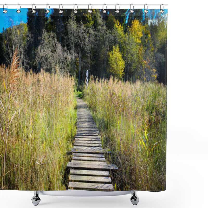 Personality  A Rustic Wooden Boardwalk Leading Through Autumn Wetlands With Tall Reeds And A Border Marker In The Background. Shower Curtains