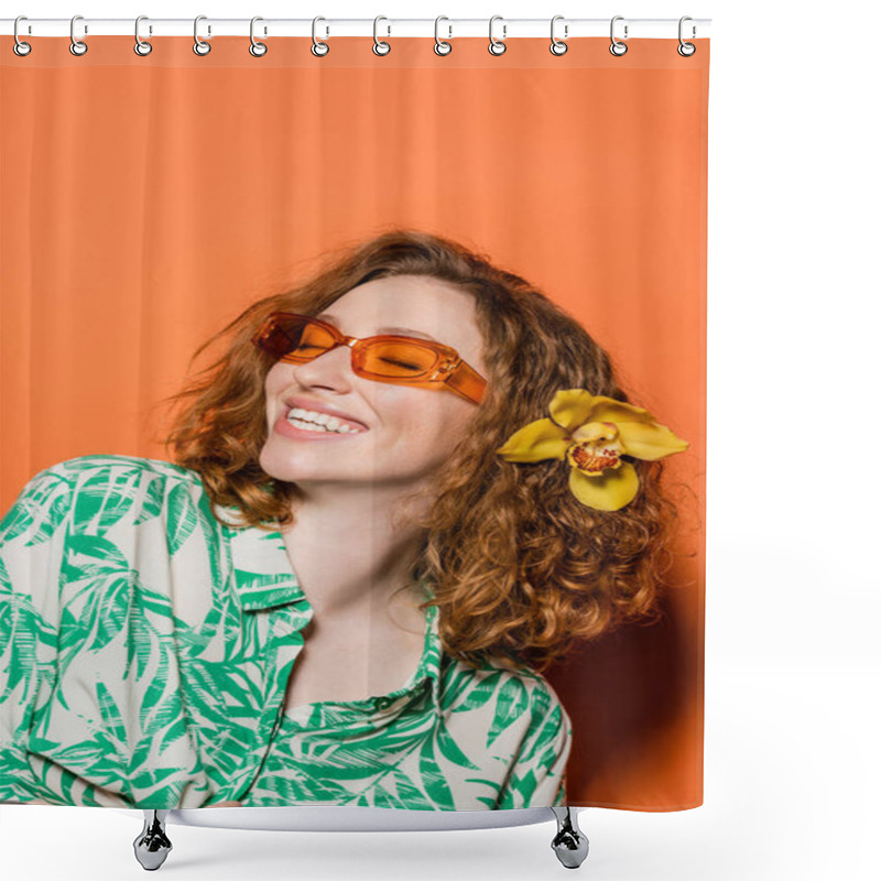 Personality  Positive Young Woman With Orchid Flower In Red Hair Wearing Sunglasses And Stylish Blouse While Standing On Orange Background, Summer Casual And Fashion Concept, Youth Culture Shower Curtains