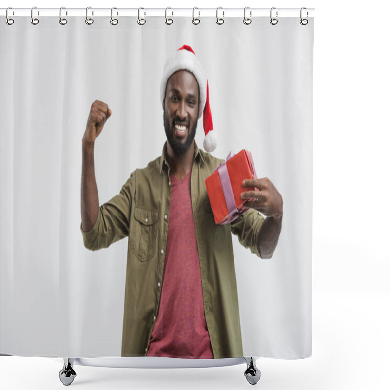 Personality  Happy Handsome African American Man In Santa Hat Gesturing And Holding Present Isolated On White Shower Curtains