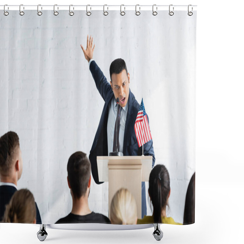 Personality  Excited Indian Agitator Gesturing While Talking To Voters In Conference Hall, Blurred Foreground Shower Curtains